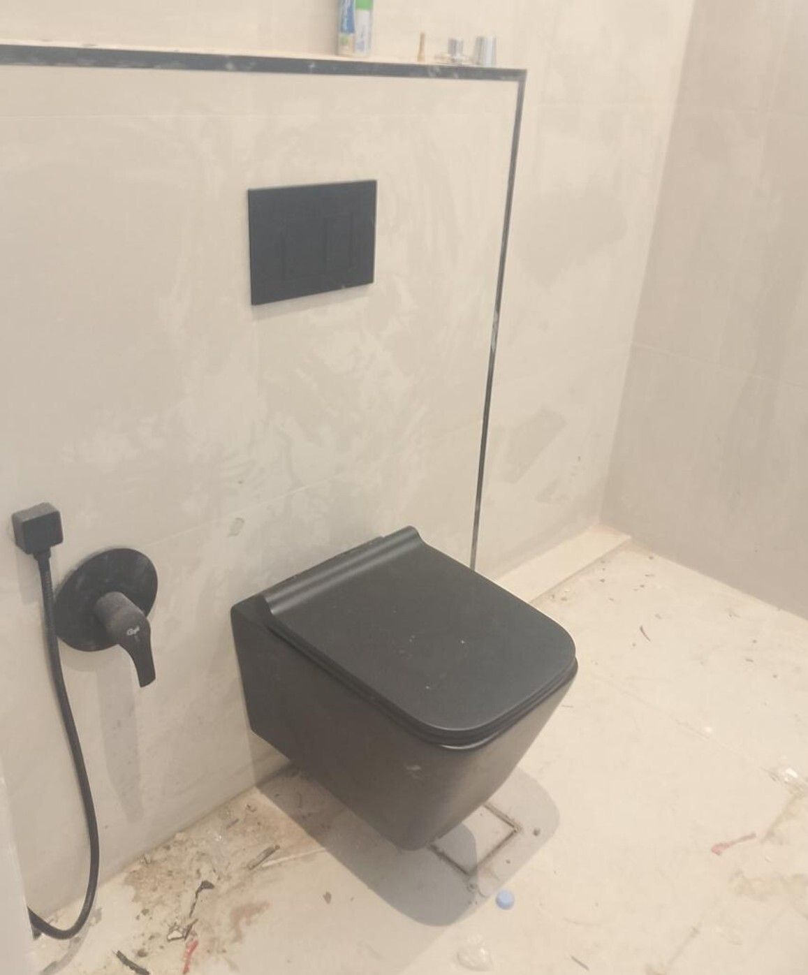 مرحاض معلّق بلوحة طرد سوداء بعد التشطيب